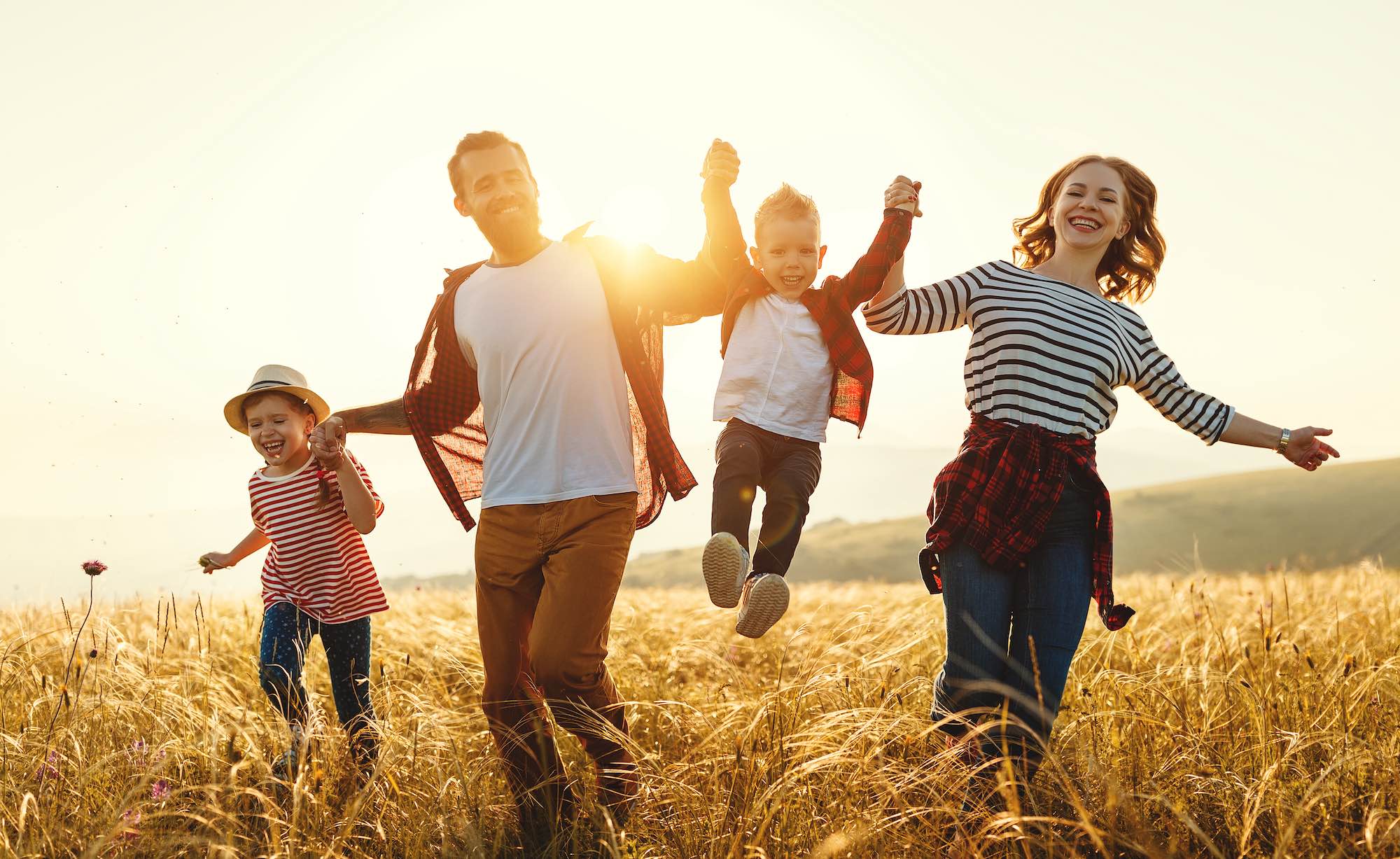 Happy family father of mother and child son on nature at sunset will